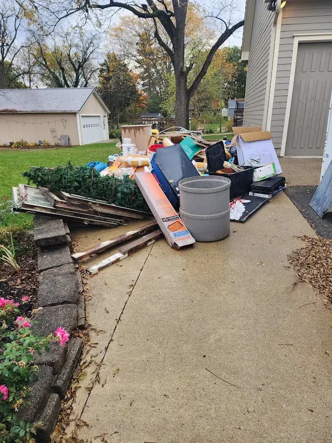 Dumpster being loaded with debris for Estate Cleanout Dumpster Rental in Pinckneyville